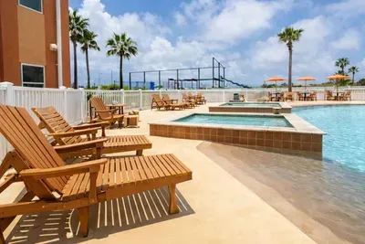 A bright, breezy poolside escape where sunlight dances on calm water and palm trees frame the day. A simple, refreshing space that invites slow mornings, easy afternoons, and relaxed moments that feel naturally coastal and carefree.