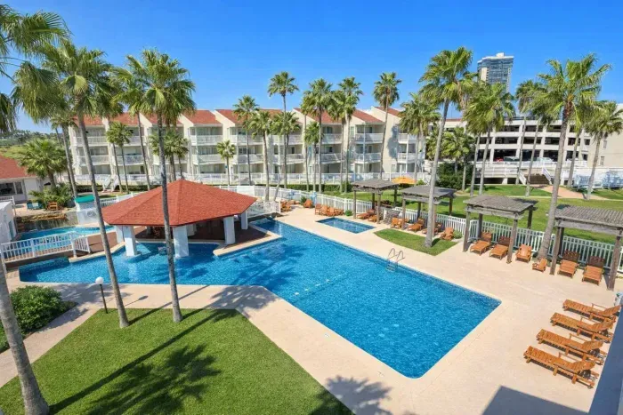 Resort-Style Condo with Pool, Pergolas & Pavilion – Walk to Beach, Dining & Entertainment