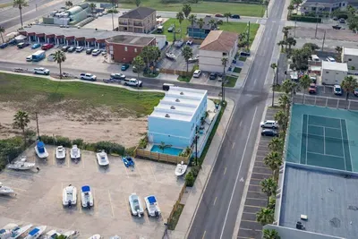 Bright coastal retreat with private pool, boat parking, and tennis courts—steps from beachside fun and dining. Ideal for families or groups seeking sun, space, and convenience in a vibrant vacation hub.