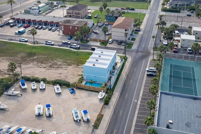 Bright coastal retreat with private pool, boat parking, and tennis courts—steps from beachside fun and dining. Ideal for families or groups seeking sun, space, and convenience in a vibrant vacation hub.