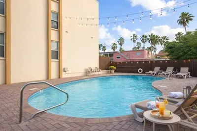 Tropical Pool Retreat | Walk to Beach | Palm Views | Cozy Outdoor Seating | No-Fee Parking