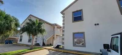 Neat, well‑kept building with tropical landscaping, easy parking, and exterior stair access to upper units. A simple, convenient setup in a warm coastal setting, offering guests a practical, comfortable base close to local attractions and beaches.