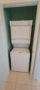 Convenient in‑unit laundry with a stacked washer‑dryer set in a tidy alcove, offering guests easy, efficient cleaning during their stay. A practical, space‑saving amenity that adds comfort, flexibility, and everyday convenience to the home.