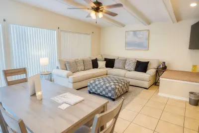 Spacious Coastal Retreat | Dining + Lounge | Near Beach
Relax in this bright, open-concept living & dining space with a comfy sectional, stylish décor and natural light. Enjoy meals at the wood dining table, unwind with smart TV & board games.