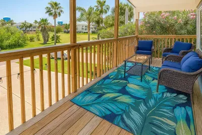 Tropical Balcony Retreat with Plush Seating & Lush Views
Unwind on a bright balcony with deep-cushioned wicker seating, vibrant tropical rug, and serene palm-lined views — perfect for morning coffee or sunset wine.
