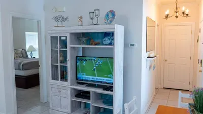 Stream your favorite shows or catch the big game on a smart TV in a stylish entertainment unit. Featuring coastal accents and thoughtful décor, this relaxing nook connects seamlessly to the living area and provides true vacation.