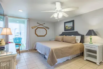 Bright Coastal Bedroom — Plush Bedding, Nautical Décor & Balcony Access for a Relaxing Beach Retreat