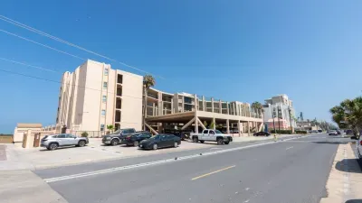 Steady, coastal building setting with a relaxed, welcoming feel—clean lines, warm tones, and an easy sense of place that fits naturally into a beachside stay. A simple, genuine exterior that sets the tone without leaning on amenities.