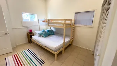 The cozy bunk room offers a twin-over-full bed, tropical pillows, bright décor ideal for kids or friends. Ample storage, colorful accents, and plenty of natural light create a cheerful, comfortable space perfect for restful nights & happy mornings.