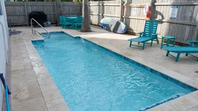 Chic Poolside Corner with Modern Loungers, Pops of Color & Serene, Fully Enclosed Patio