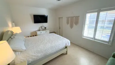 A bright, calming bedroom with soft natural light, simple textures, and an easy, uncluttered layout that feels instantly welcoming. A relaxed space to settle in, recharge, and enjoy slow moments throughout your stay.