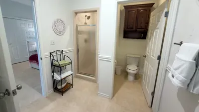 A bright, well‑kept bathroom with a simple, open layout that feels easy to move through, offering a calm reset between moments of the day. Soft tones and tidy details create a space that supports a relaxed, unhurried rhythm throughout your stay.