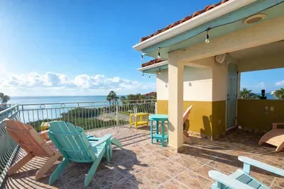 Oceanview Rooftop Patio with Pastel Seating & String Lights – Steps to Beach, Perfect for Sunset Lounging & Morning Coffee