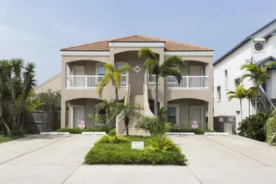 Spacious Two‑Story Retreat with Dual Balconies, Tropical Landscaping & Private Driveway — Perfect for Relaxed Coastal Getaways