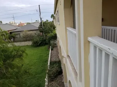 Looking down from patio on 3. Lot next door is empty