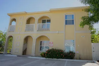 Stay in this bright, welcoming two‑story retreat featuring classic arches, a private balcony, sunny coastal charm. With easy parking, vibrant landscaping and a clean, well‑kept exterior, it offers a comfortable, convenient base for island adventures.