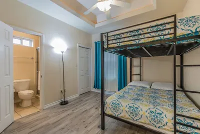 full sized adult beds on the bunk. Still enough room to throw down an airbed if you so choose. Full bathroom walk in shower in the bedroom. Super high trell ceilings and wood look hard tile.