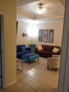 Living room from afar. Has fold down sleeper sofa. With the 3rd bathroom off the living room kids don't have to enter the bedrooms to use the loo.