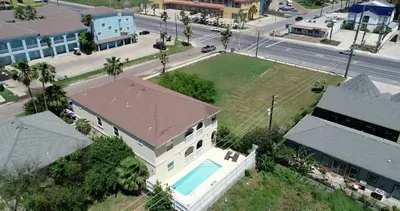 Aerial shot of 4 plex in relation to Padre blvd. Pool in back