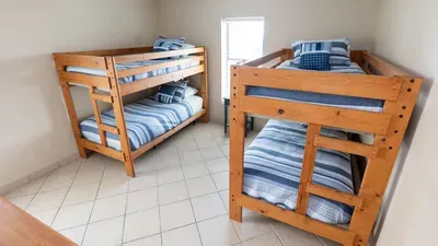 Cozy bunk‑beds room designed for comfort and convenience, featuring soft natural light, a sturdy wooden frame and ample storage. A great space for kids or groups, offering a practical, welcoming setup perfect for relaxed vacation stays.