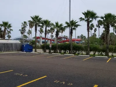Vibrant coastal entry point surrounded by tall palms, colorful local buildings, and relaxed beach‑town energy. A convenient, welcoming area that sets the tone for easy access, smooth arrivals, and a laid‑back tropical stay experience.