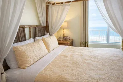 Coastal Canopy Retreat | Ocean View | Steps to Beach  
Relax in this breezy, beach-inspired bedroom with a four-poster bed, natural textures, and bright coastal charm. Perfect for couples or solo travelers seeking serenity by the sea.