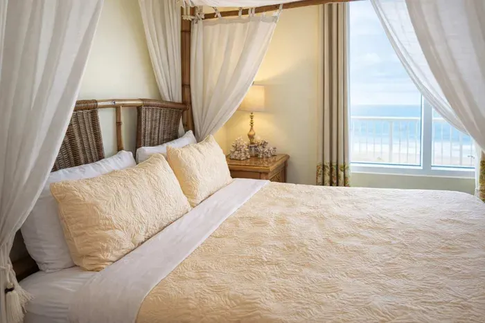 Coastal Canopy Retreat | Ocean View | Steps to Beach  
Relax in this breezy, beach-inspired bedroom with a four-poster bed, natural textures, and bright coastal charm. Perfect for couples or solo travelers seeking serenity by the sea.