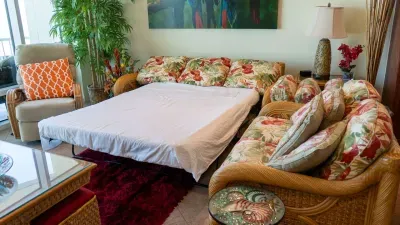 Cozy living space with an easy, laid‑back feel—soft tones, simple décor, and a comfortable setup that makes settling in feel natural. A warm, genuine room that brings a relaxed coastal vibe to the stay without relying on amenities to define it.