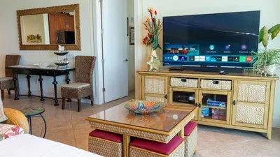 Warm, easygoing living area with a clean layout and relaxed coastal character—natural tones, simple décor, and a comfortable setup that makes settling in feel effortless. A genuine, welcoming space that supports an unhurried stay.