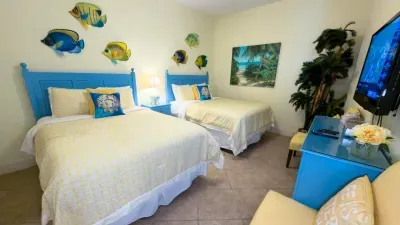 Bright, cheerful bedroom with a playful coastal touch—soft colors, simple décor, and an easy layout that feels naturally welcoming. A relaxed, genuine space that brings a light, breezy vibe to the stay without relying on amenities to define it.