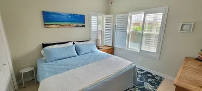 Wake up to coastal serenity in this bright, inviting bedroom featuring soft blue tones, natural light, and modern comforts—perfect for couples, families, or groups seeking relaxation, style, and memorable seaside stays.