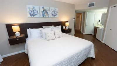 Soft, coastal bedroom retreat with warm lighting and clean lines — a calm space that feels instantly welcoming. Thoughtful design and gentle tones create an inviting atmosphere perfect for unwinding after sun‑filled days by the shore.