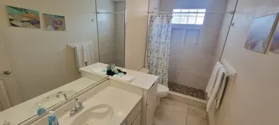 Fresh, modern bathroom with a walk‑in shower, bright tilework, and natural light that creates a clean, spa‑like feel.