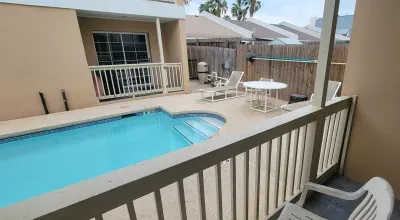 Inviting pool deck with crystal‑clear water, comfy seating, and a private fenced backdrop. A perfect spot for morning coffee, afternoon swims, and relaxed evenings under the open sky.