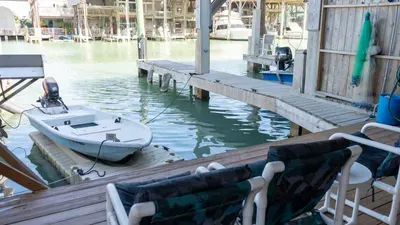 Relax on the waterfront deck with comfortable seating, a private dock, and serene canal views. Perfect for morning coffee or sunset unwinding, this peaceful outdoor space offers direct water access and a calm coastal vibe throughout.