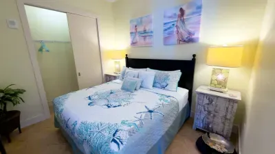 A soft, coastal bedroom with gentle colors, warm lighting, and simple décor that creates an easy, welcoming feel. The relaxed layout and calm styling make the space feel naturally comfortable, offering a peaceful spot to unwind throughout the stay.