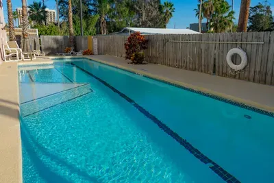 Sunlit Pool Retreat
Sparkling outdoor pool with palm‑lined views, ample seating, and a peaceful fenced setting—perfect for relaxing swims, family fun, and warm‑weather lounging.