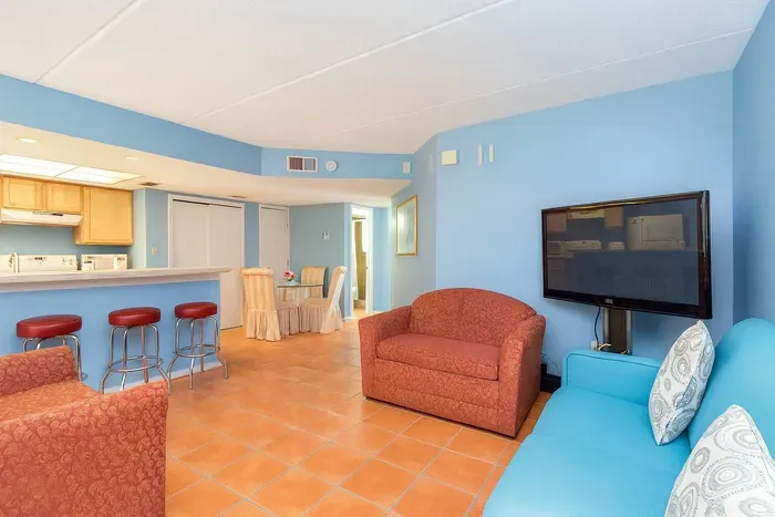 Bright Coastal Retreat Near Beach w/ Full Kitchen & Dining Space
Spacious open-plan living with vibrant seating, full kitchen, and cozy dining area. Light blue walls, terracotta tiles, and natural wood accents create a warm, beachy vibe.