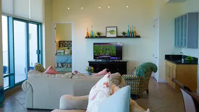 A bright, relaxed living space with soft tones, natural light, and an easy flow that feels instantly welcoming. The simple décor and open layout create a calm, unhurried atmosphere, offering a comfortable spot to unwind and enjoy time together.