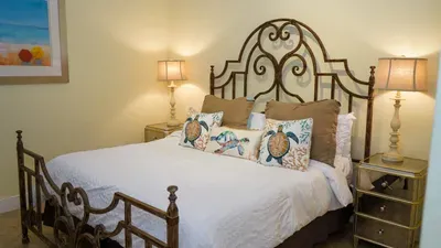 A calm, coastal bedroom with soft colors, simple décor & an easy layout that feels naturally welcoming. The relaxed styling & gentle tones create a comfortable, unhurried atmosphere offering a peaceful place to settle in & unwind throughout the stay.