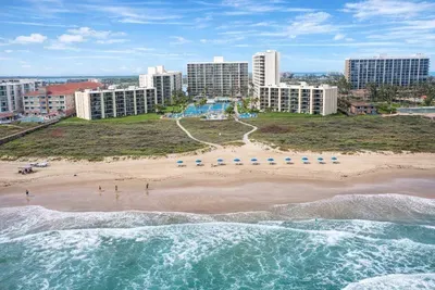 Beachfront resort with ocean views, poolside paradise, and direct beach access—perfect for family getaways or romantic escapes. Walk to the waves, relax under blue umbrellas, and enjoy spacious condos with private balconies and lush landscaping.