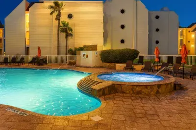 Delight in poolside relaxation at this oceanfront condo featuring a sparkling swimming pool, inviting tub, and stylish loungers. After a day at the beach, unwind in comfort with expansive outdoor amenities and tranquil coastal views.