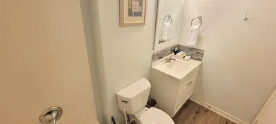 Clean Coastal Bathroom — Fresh Vanity, Wooden Color Tile Accents & Tub/Shower Combo
