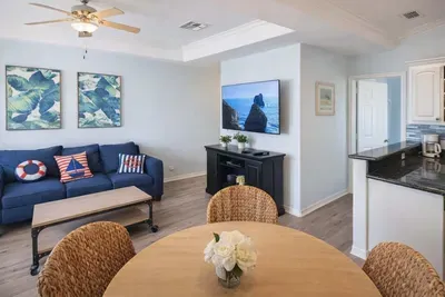 Coastal Retreat w/ Bright Interiors, Navy Sofa, Tropical Art, Full Kitchen & Dining Nook – Steps to Beach!
