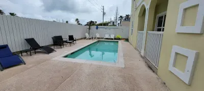 This welcoming pool area offers comfortable seating, warm light, and a tidy deck perfect for relaxing. Guests can lounge, soak up the atmosphere, and enjoy a refreshing break in a clean, well‑kept outdoor setting.