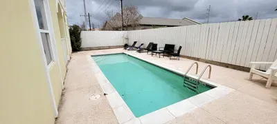 Enjoy this bright poolside area featuring lounge chairs, warm sunlight, and a clean, inviting deck. The relaxed setting offers a refreshing spot for guests to unwind, cool off, and enjoy easy vacation downtime throughout the day.