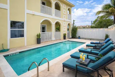 Relax by the Outdoor Pool at This Bright 2BR Coastal Retreat — Steps from Dining & Beaches