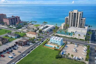 Bright coastal retreat near the Gulf with pool, boat parking, and walkable beach access. Ideal for families or groups seeking sun, serenity, and convenience in a vibrant waterfront neighborhood.