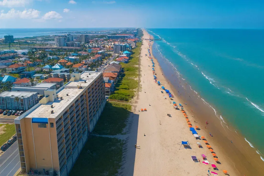 Prime Beachfront Condo Aerial Panorama
Elevate your stay in this oceanfront high-rise condo, steps from golden sands and vibrant boardwalk. Aerial views showcase endless blue waters, colorful umbrellas dotting the beach, and lively coastal skyline.