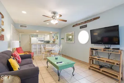 A cozy, colorful gathering space with an easy coastal warmth, where relaxed seating and soft, lived‑in touches create a welcoming flow. It’s a bright, comfortable spot that naturally invites conversation, downtime, and simple moments together.